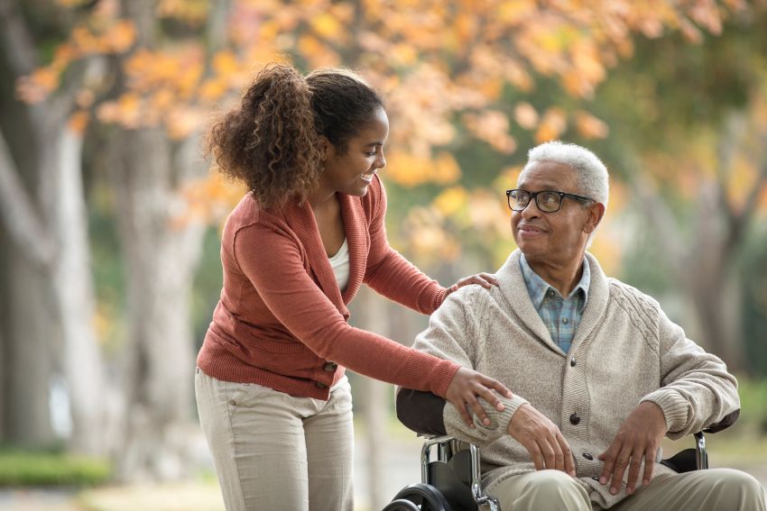 woman-pushing-father-in-wheelchair